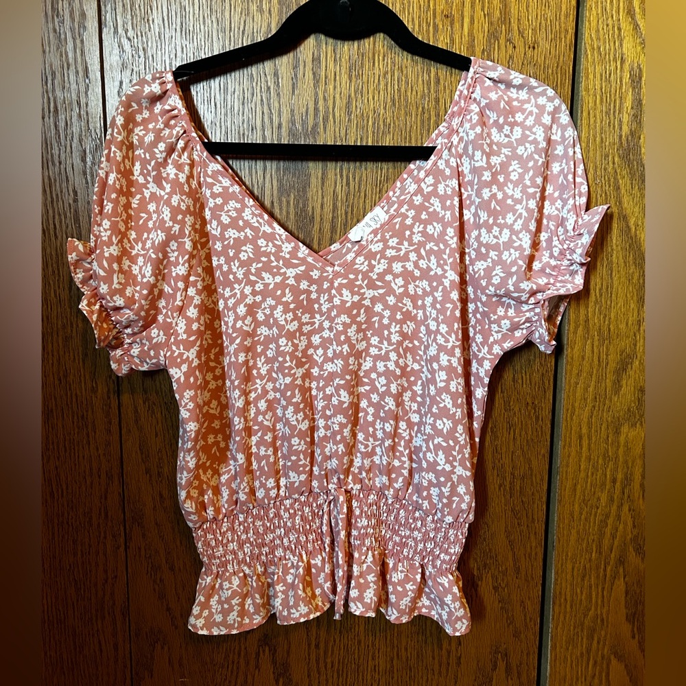 Pink top with white flowers size small.